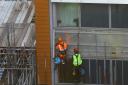 Workmen removing cladding from a block of flats in Paddington in December