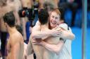 Great Britain's Tom Dean and James Guy celebrate gold in the Men's 4x200 freestyle relay at Tokyo Aquatics Centre.