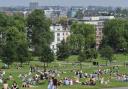 People enjoy the hot weekend weather and the views on north London's Primrose Hill.