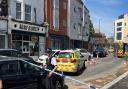 Church Road in Willesden is closed, after a man fell from a height