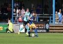 Wealdstone midfielder Charlie Cooper battles for the ball at King's Lynn Town