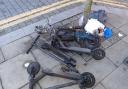 The charred remains of an e-scooter after it caught fire in Kilburn at the weekend