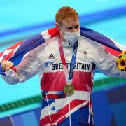 Great Britain's Tom Dean with his gold medal celebrates after winning the Men's 200m Freestyle at Tokyo Aquatics Centre on the fourth day of the Tokyo 2020 Olympic Games in Japan