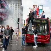 England fans climb aboard a bus outside the ground ahead of the UEFA Euro 2020 Final at Wembley Stadium