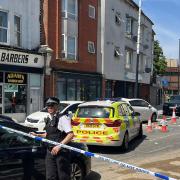 Church Road in Willesden is closed, after a man fell from a height