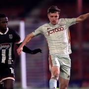 Grimsby Town's Ira Jackson (left) and Bradford City's Elliot Watt battle for the ball during the Sky Bet League Two match at Blundell Park, Grimsby.