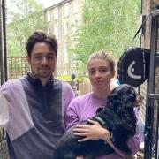 Ben Shingler and Catherine Harris with their dog Toby outside their flooded Kilburn flat