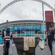 Cleaning staff make final preparations to Olympic Way hours before 60,000 fans are set to descend to Wembley Park to watch England play Denmark