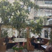 People enjoy the garden as the Parlour, in Kensal Green, reopens on April 12