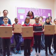 Paul Lorber, Barham Primary School head Karen Giles, IT co-ordinator Paulette Williamson and pupils with the new donated laptops and internet dongals from Friends of Barham Park Library