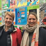 Sarah Reynolds and Hilary Brigden of Salusbury World infront of a Stonebridge Primary school project currently at Willesden Library. Picture: Nathalie Raffray