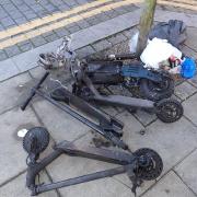The charred remains of an e-scooter after it caught fire in Kilburn at the weekend