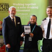 (L-R) National Pubwatch chair Steve Baker OBE, JJ Moons barman Jean-Luc Julienne, and South Yorkshire Police Chief Superintendent Ian Proffitt