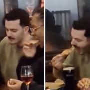 A man was caught dipping a slice of Domino's pizza in a pint of Guinness on camera and the video has gone viral