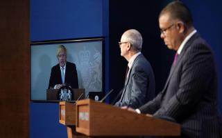 Prime minister Boris Johnson appears on a screen from Chequers, where he is self-isolating,  during a coronavirus media briefing